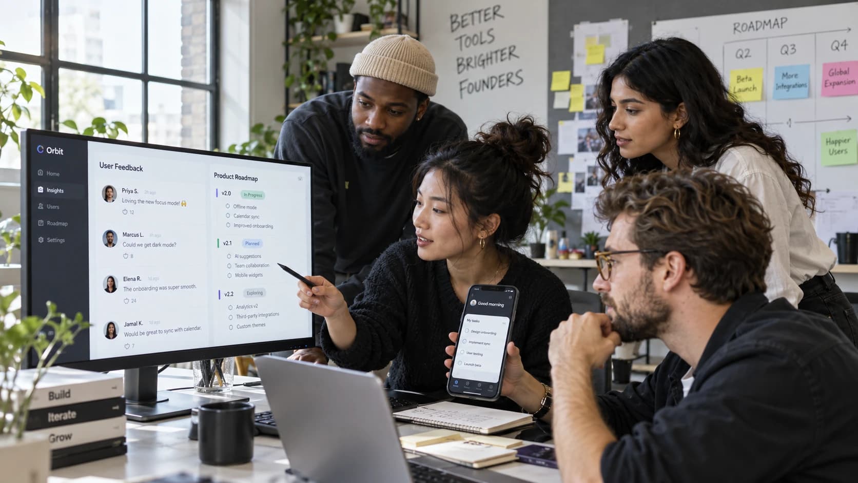 Startup founders reviewing customer feedback and a product roadmap together